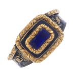 A late Georgian gold enamel mourning ring. The central replacement blue hardstone to the foliate