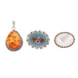 A selection of jewellery. To include an oval locket, a micro mosaic brooch, a floral marcasite