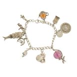 Three charm bracelets. All of curb-link design suspending a total of twenty-six charms, including an