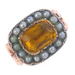 A late Victorian gold gem set ring. Designed as a rectangular yellow paste, with split pearl