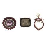 Three early to mid Victorian brooches. The first of roughly heart-shape with red gems to the