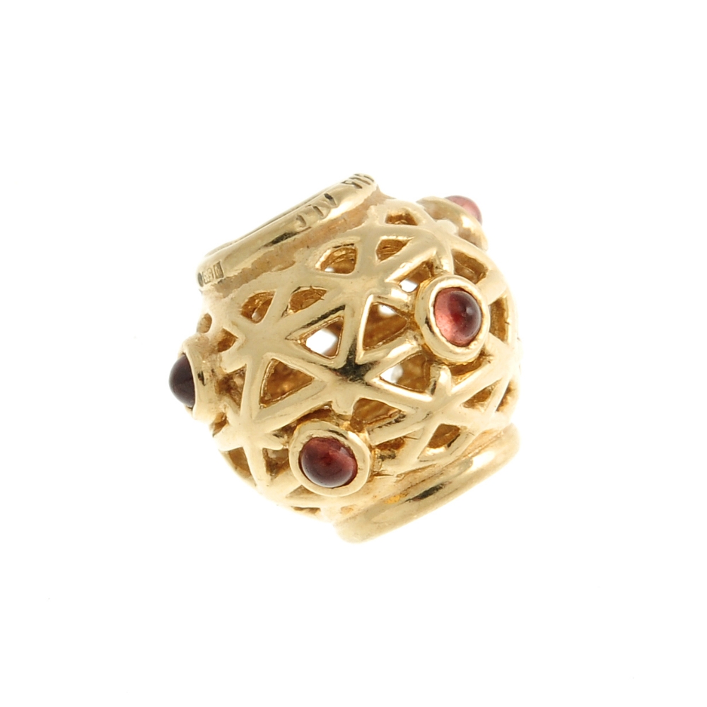 PANDORA - a gold charm. Designed as a spherical bead with intersecting diagonal lines and circular