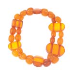 A natural amber bracelet and loose natural amber beads. The bracelet comprising two rows of oval-