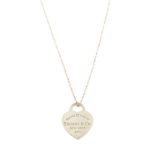 TIFFANY & CO. - a pendant. Designed as a heart-shape panel stamped 'Please Return To Tiffany & Co.