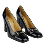 GUCCI - a pair of patent Horsebit heeled court shoes.