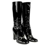 GUCCI - a pair of mid-calf patent Horsebit boots.