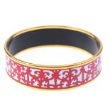 HERMÈS - a 'Balcons Du Gualdalquivir' bangle. The closed bangle with scrolling red enamel patterns