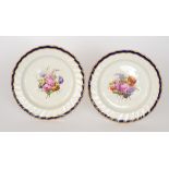 Two early 19th Century Derby porcelain cabinet plates each decorated to the central well with a