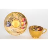 A Royal Worcester fruit painted teacup and saucer decorated by Ricketts,