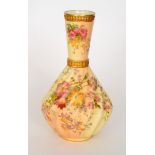 An early 20th Century Royal Worcester blush ivory vase of wrythen form with a flared collar neck,