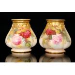 A matched pair of Royal Worcester cache pots of lobed form and decorated with a hand painted