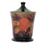 A William Moorcroft cylindrical box and domed cover decorated in the Pomegranate pattern with a