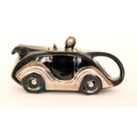 A 1930s Sadler teapot modelled as a black racing car with silver lustre trims,