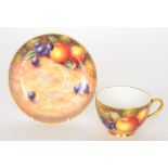 A Royal Worcester fruit painted teacup and saucer decorated by Freeman,