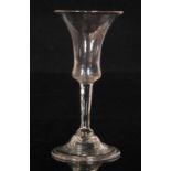 An 18th Century drinking glass circa 1745, large bell form bowl above a plain stem with basal knop,