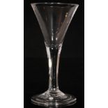 An 18th Century drinking glass circa 1750, large drawn trumpet bowl above a plain stem,