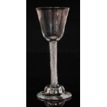 An 18th Century drinking glass circa 1755, round funnel bowl above a multiple series air twist stem,