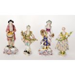 Two pairs of 19th Century Continental figurines, the first modelled as market sellers,