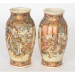 A pair of late 19th Century Satsuma baluster vases each panel decorated with figures on a balcony