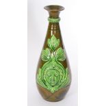 Ault Pottery - A late 19th Century vase of skittle form decorated to each side with a relief