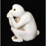 Bernard Moore - An unglazed model of a crouching monkey with its paws to its mouth, unmarked,