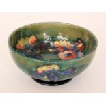 A Moorcroft footed bowl decorated in the Frilled Orchid pattern decorated to the interior with