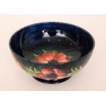A large Moorcroft Anemone pattern footed bowl decorated to the interior with a large pink flower