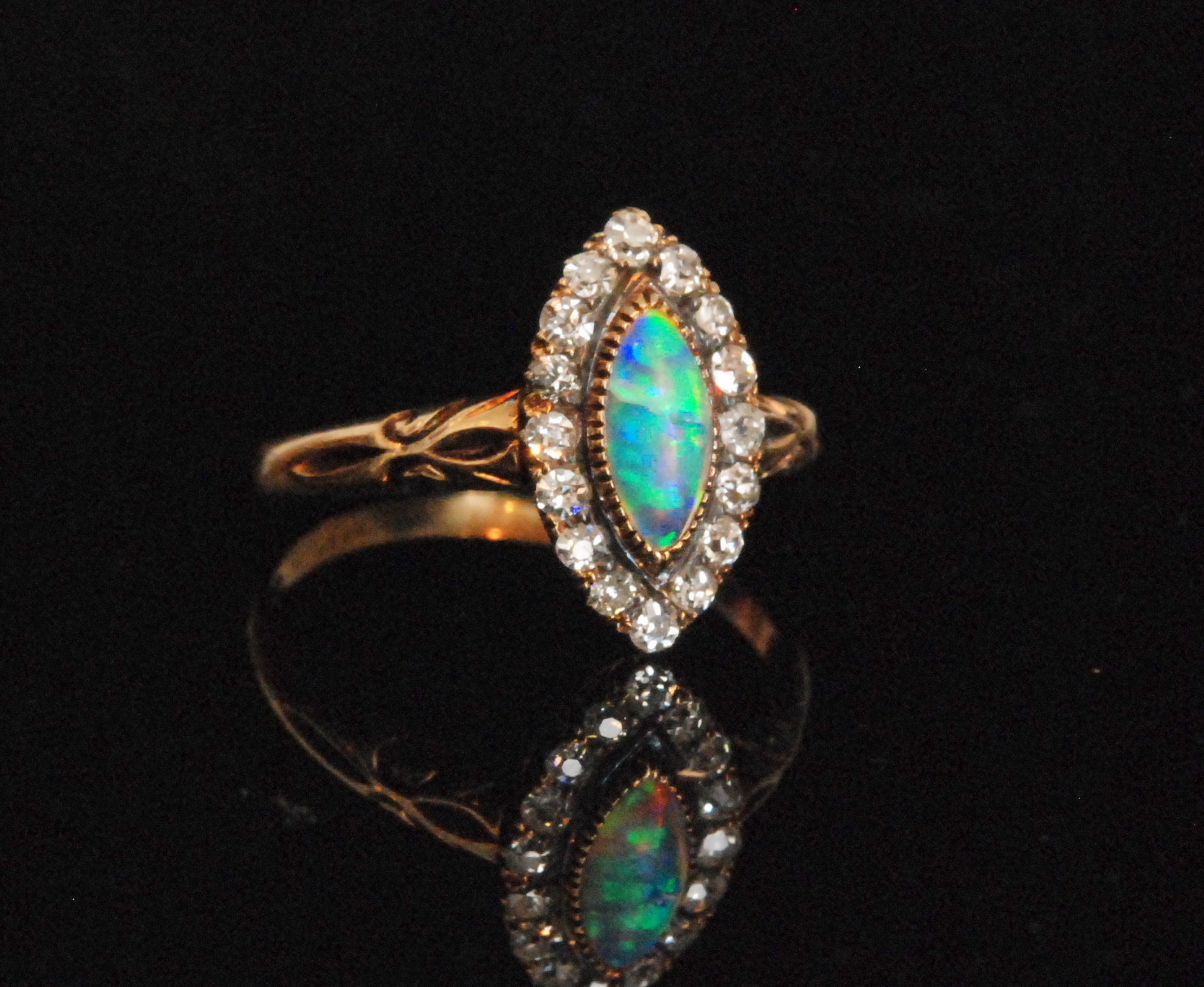 An early 20th Century 18ct opal and diamond cluster ring,