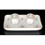 A late 19th Century Meissen ink stand of rectangular form mounted with two cylindrical ink pots,