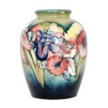 A Moorcroft Frilled Orchid pattern vase of swollen form decorated with tonal flowers and foliage