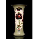A Moorcroft Panel Persian trumpet vase decorated with panels of flowers against a celadon ground,