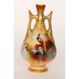 A Royal Worcester twin handled vase decorated by Bray with pheasants perched upon pine branches,