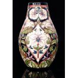 A Moorcroft Pottery vase decorated in a floral pattern with stylised flowers and foliage designed