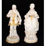 A pair of 19th Century bisque figurines modelled as a lady and gentleman in white with gilt