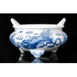 A Chinese blue and white bowl of compressed circular form with roll rim and applied arched handles,