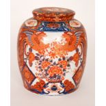 A 20th Century Chinese export jar and cover decorated in burnt red and blue with two panels of