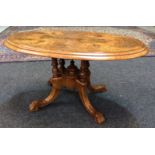 A Victorian walnut occasional table of oval form with foliate inlaid detail,