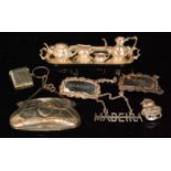 A hallmarked silver miniature four piece tea set and tray, a silver purse,