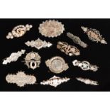 Eleven early 20th Century hallmarked silver sweetheart brooches of various designs to include a