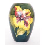 A Moorcroft vase of tapering form decorated in the Hibiscus pattern with tubelined flowers against