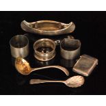 A small parcel lot of assorted silver items to include model of a canoe, three silver napkin rings,