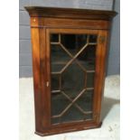 A Georgian style mahogany corner cupboard with line inlaid frieze above an astragal glazed door,