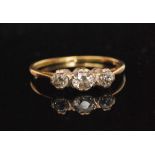 An 18ct diamond three stone ring, central rose cut diamond flanked by two smaller diamonds,