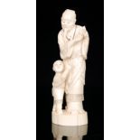 A late 19th to early 20th Century Japanese carved ivory figure of a sage holding a peach stone,