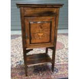 A Victorian inlaid rosewood music cabinet the interior enclosed by a door decorated with an urn and