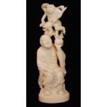 A late 19th to early 20th Century carved ivory figure of a seated robed peasant holding a peach
