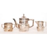 An Orivit polished pewter three piece tea set of plain circular form detailed with a panel frieze,
