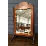 A oak and walnut framed toilet swing mirror of small proportions, with fret-cut frame, width 30cm.