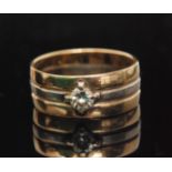 A 9ct two tone diamond set ring designed as two bands of yellow gold spaced by a white gold band