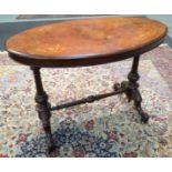 A Victorian walnut occasional table of oval form with foliate inlaid detail,